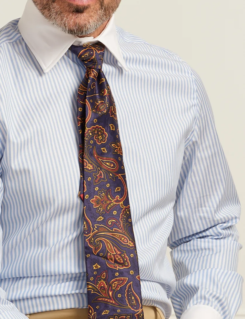 close up of blue striped shirt with white collar and paisley tie