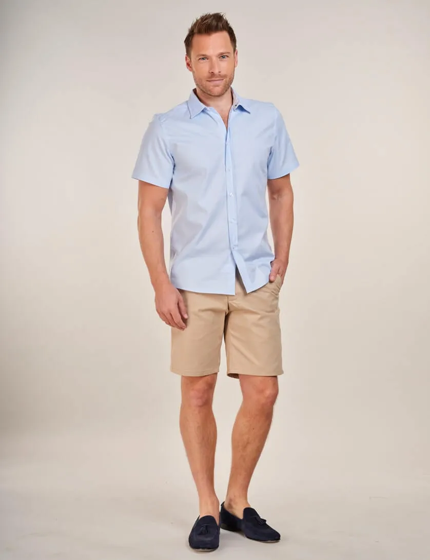 light blue short sleeve shirt with beige chino shorts